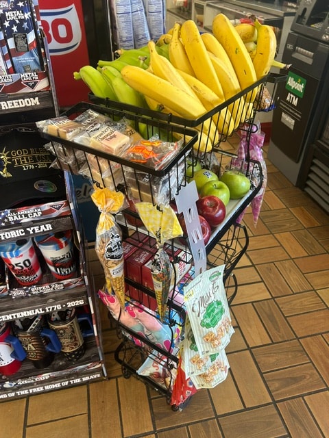 Retail cart display with bananas, apples and packaged goods