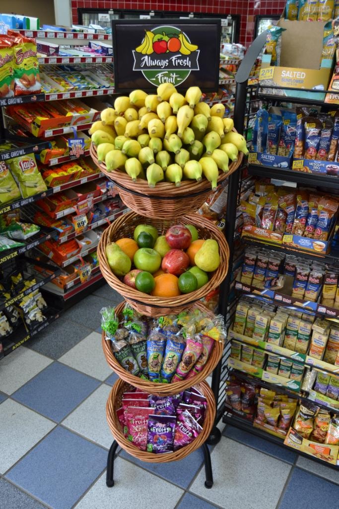 4-tier basket display with bananas, mixed fruit and Kettle Creek almonds