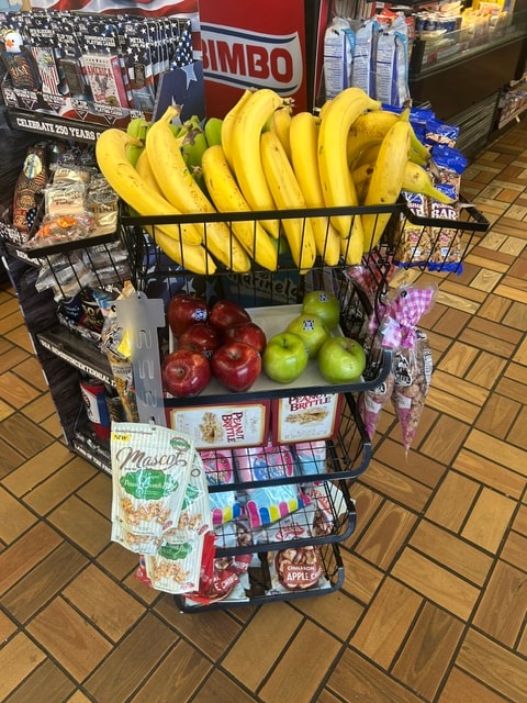 Store display with bananas, apples and packaged goods