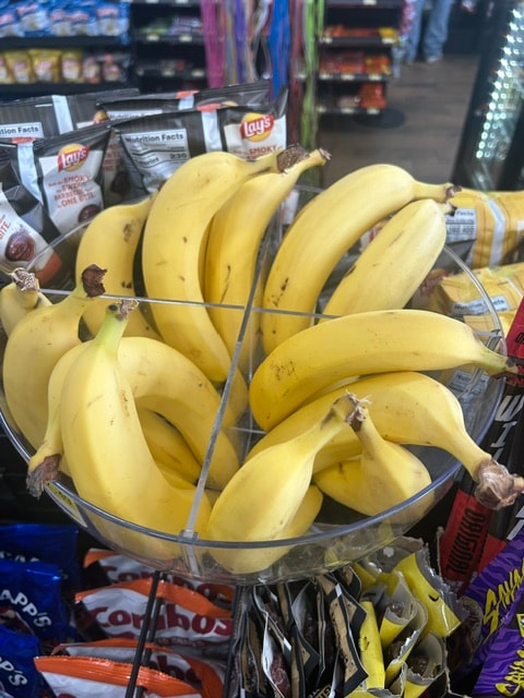 Fresh bananas displayed on convenience store shelf
