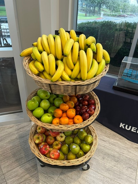Tiered fruit display with bananas, apples, and citrus